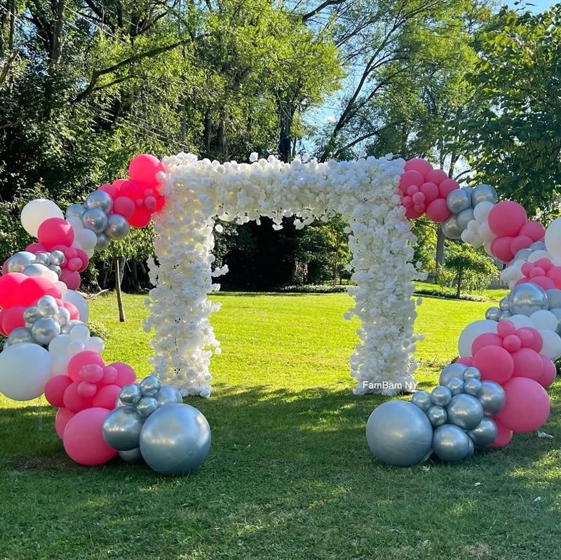 Pink and silver balloon arch with white floral pillars decorated by TSquare Luxury Events